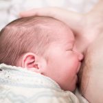 Young,Mother,Breastfeeding,With,Nipple,Shield.,She,Holds,Her,Newborn