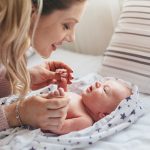 Home,Portrait,Of,A,Newborn,Baby,With,Mother,On,The
