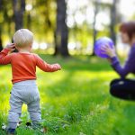 Toddler,Boy,With,His,Young,Mother,Playing,With,Ball,At