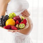 Pregnant,Woman,Holding,Fruit,Plate