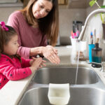Cute,Little,Girl,And,Mother,Washing,Their,Hands,Together,In