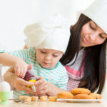 Mother,And,Little,Girl,Making,Cookies,Together,At,Kitchen