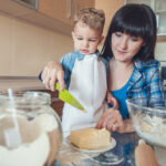 Mother,Helping,Son,Cut,Butter,With,Plastic,Knife