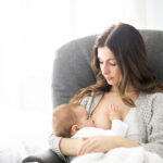 A,Young,Mother,Holding,Her,Baby,Child.,Mom,Nursing,Baby.