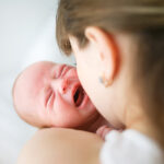 Mother,Holding,Her,Crying,Little,Son,In,Studio