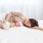 Adorable,Newborn,Baby,Sleeping,On,Bed,In,Mother,Arm,Nursing,