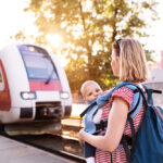 Young,Mother,Travelling,With,Baby,By,Train.