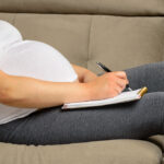 Pregnant,Woman,Making,Packing,List,For,Maternity,Hospital,At,Home
