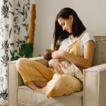 Newborn,Baby,Boy,Sucking,Milk,From,Mothers,Breast.,Portrait,Of