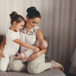 Mother,With,Infant,Boy,And,Child,Girl,Having,Fun,At
