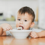 A,Charming,Child,In,A,T-shirt,In,The,Kitchen,Eats