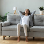 Happy,Millennial,Girl,Sit,Relax,On,Comfortable,Couch,In,Living