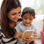 Indian,Mother,And,Child,Playing,Game,On,The,Smartphone