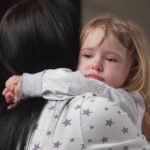 Mom,Soothes,Her,Daughter,,Child,Cries,In,Room,In,Arms