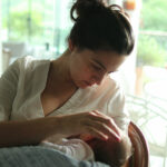 Mother,Breastfeeding,Baby,While,Caressing,Showing,Affection,And,Love