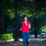 Young,Indian,Woman,With,Earphones,Listening,Music,During,Jogging,At