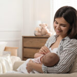 Young,Woman,Breastfeeding,Her,Little,Baby,At,Home,,Space,For