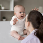 Happy,Excited,Baby,Laughing,At,Mom,Face,,Showing,Positive,Emotions,