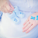 Pregnant,Mother,Expecting,Twins,Keeping,Numbers,And,Child,Socks,In