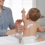 Mother,Applying,Body,Cream,On,Her,Little,Baby,At,Home,