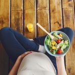 View,From,Above,Of,Pregnant,Woman,With,Fresh,Salad,Bowl