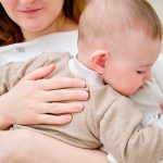 A,Mother,Woman,Holds,An,Infant,Baby,To,Regurgitate,Excess