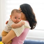 Beautiful,Caucasian,Newborn,Baby,Burping,Gas,In,The,Arms,Of