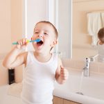 Boy,Cleaning,Teeth,In,Bathroom