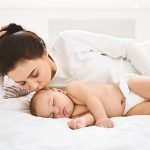 Warm,Mother’s,Love.,Young,Mother,Kissing,Her,Sleeping,Newborn,Baby