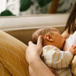 Newborn,Baby,Boy,Sucking,Milk,From,Mothers,Breast.,Portrait,Of