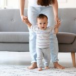 Little,Baby,Boy,Learning,To,Walk,With,His,Mother’s,Help